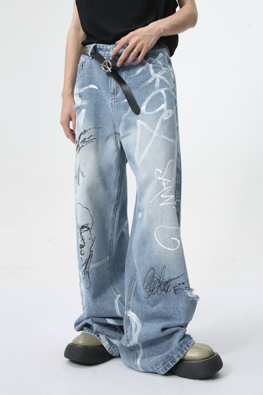 Mid rise graffiti print distressed wide leg jeans.